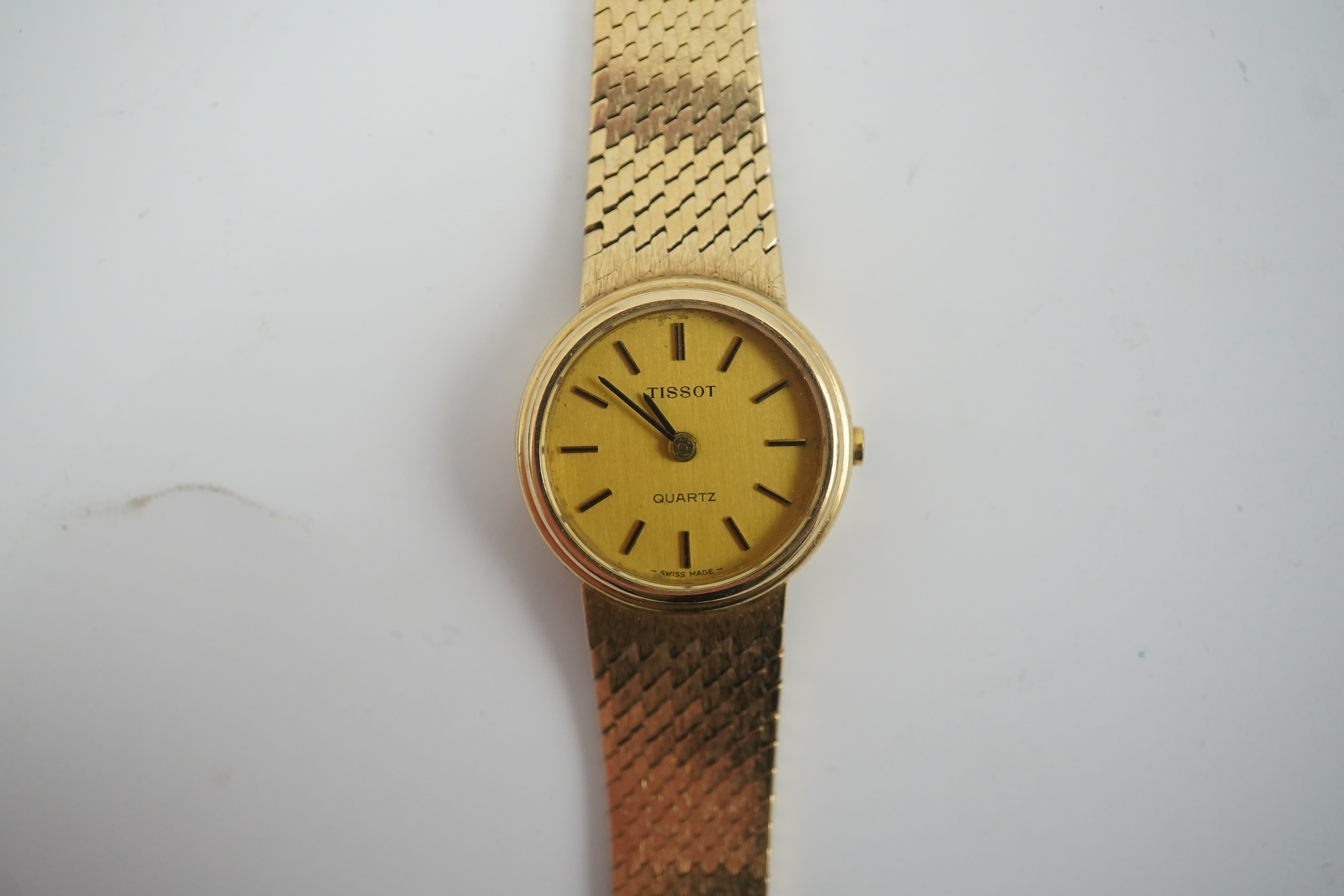 A lady's early 1980's 9ct gold Tissot quartz wrist watch with textured 9ct gold associated bracelet